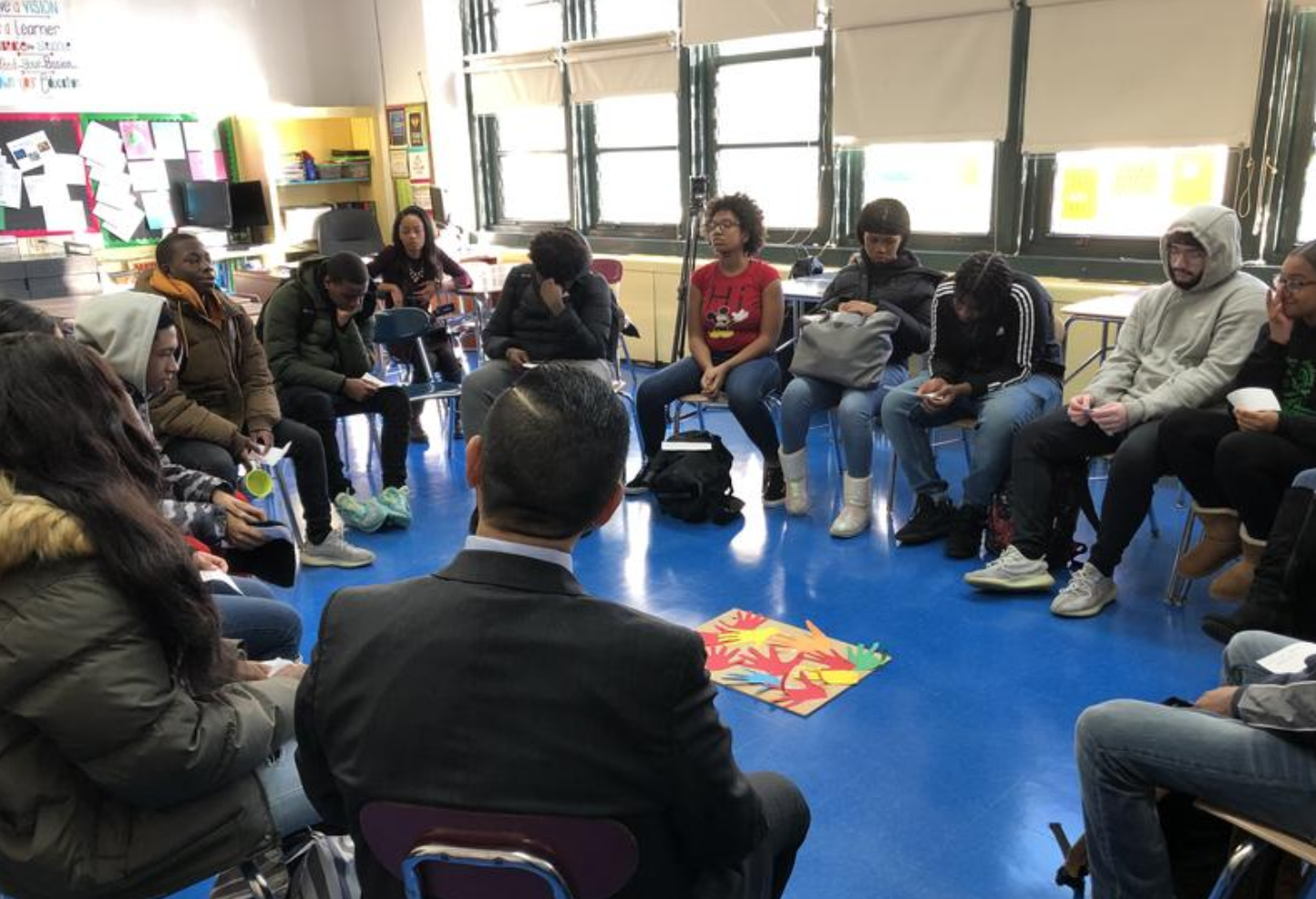 Students at the Brooklyn Academy of Finance in a circle