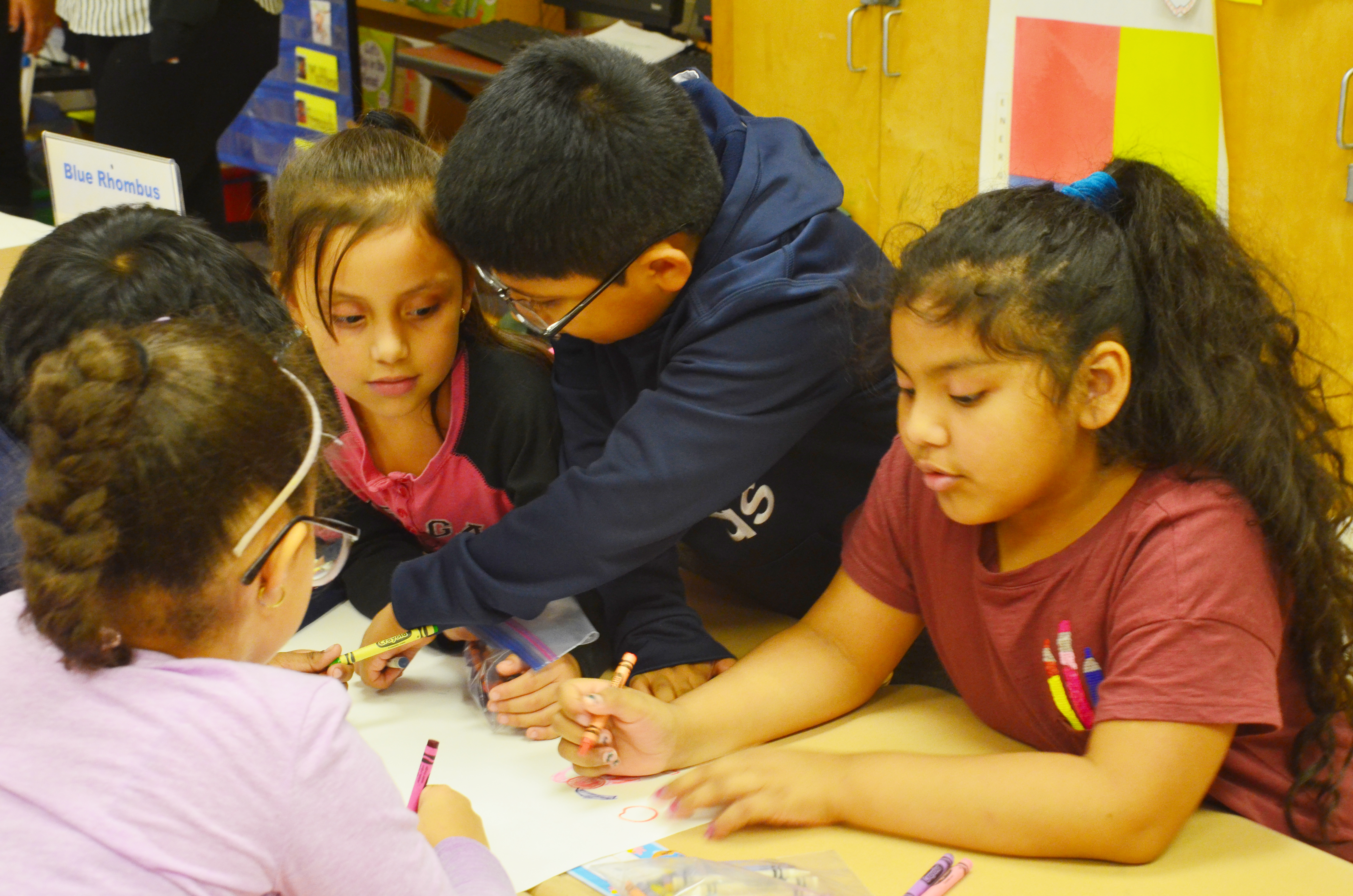 elementary school students working on an art project together