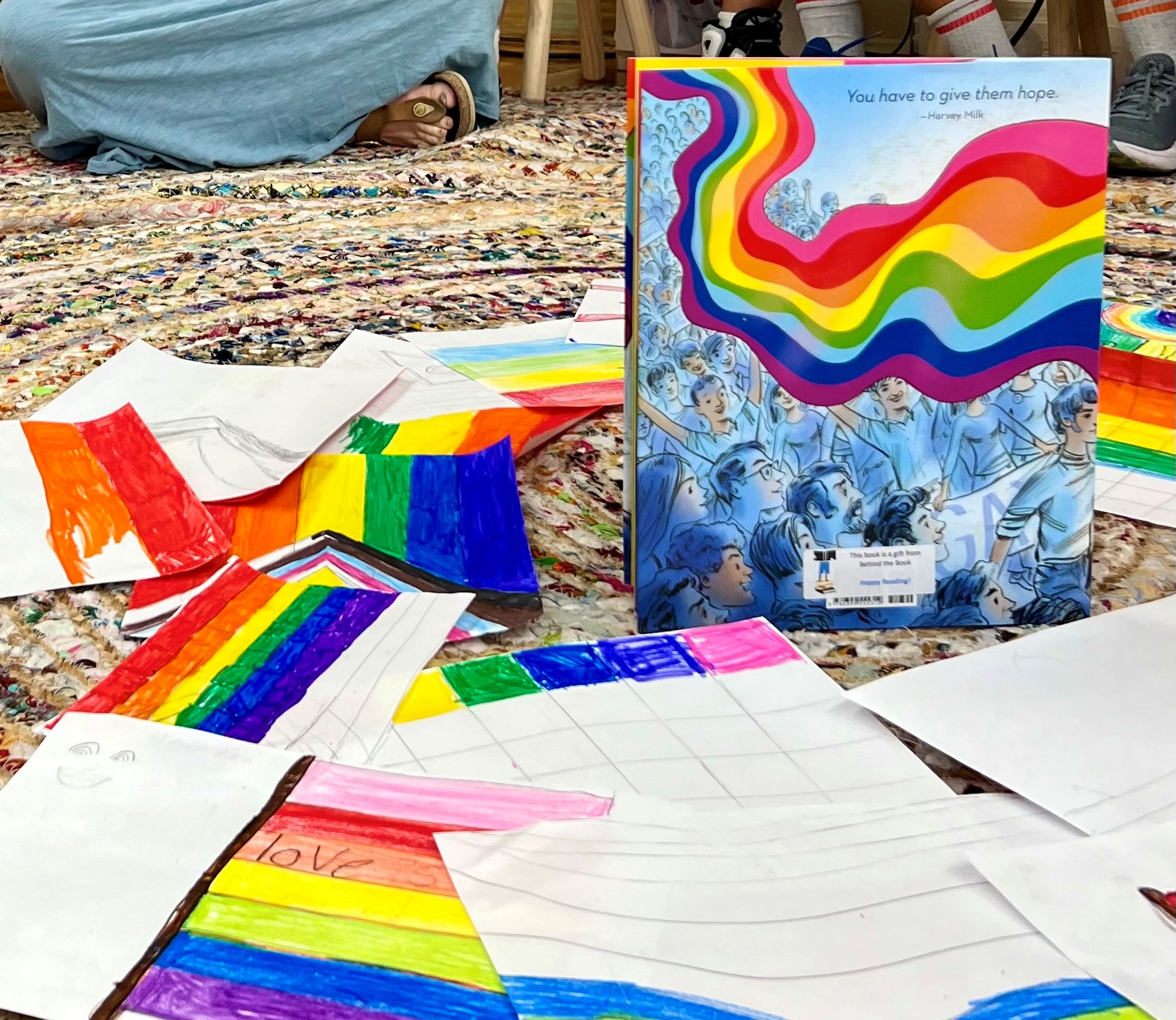 photo of a book and drawn pride flags