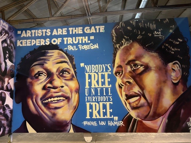 A mural featuring quotes by Paul Robeson and Fannie Lou Hamer