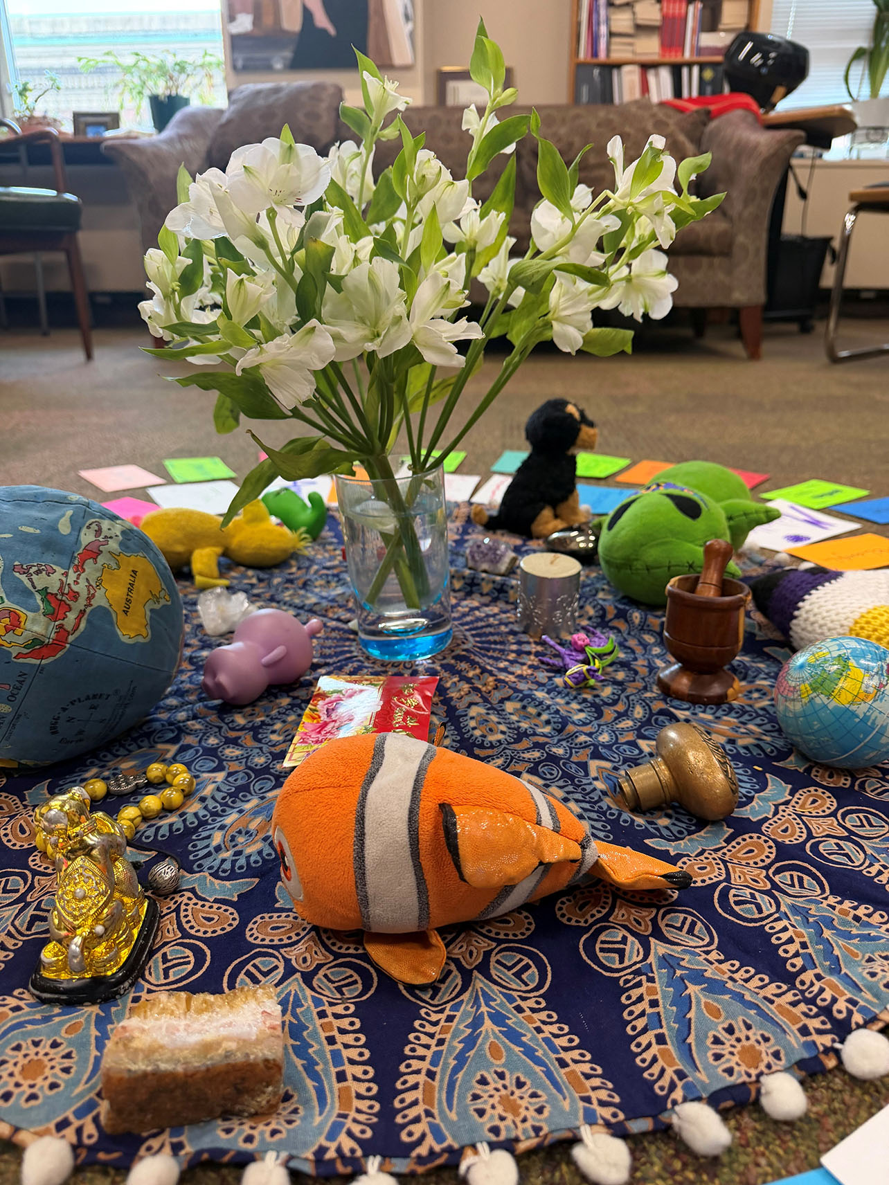 a centerpiece with flowers in the middle of it