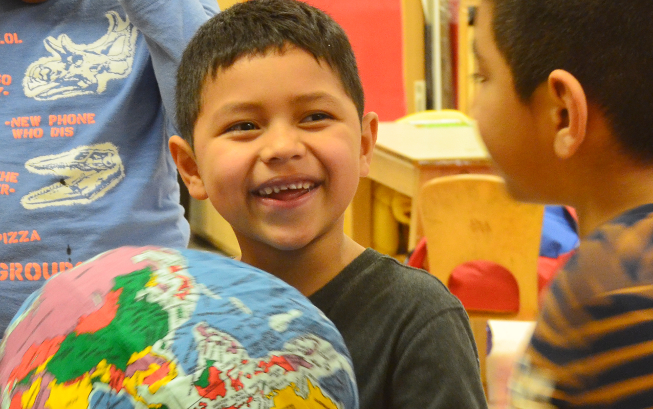 student holding hugg-a-planet